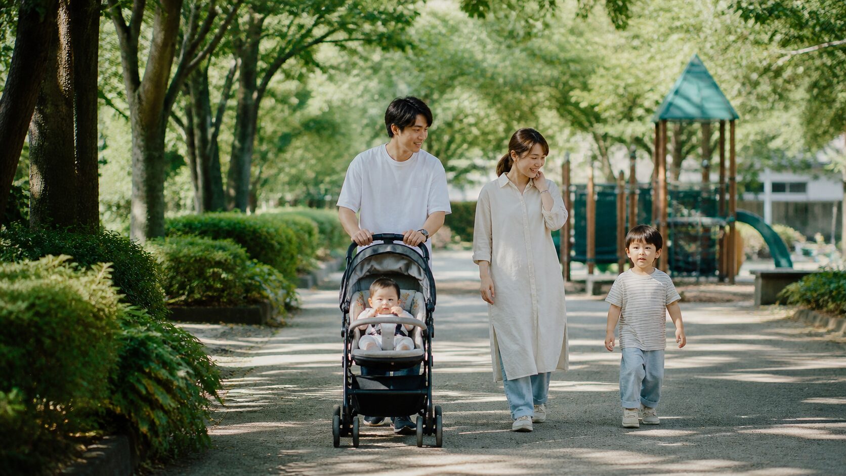 みよしの公園を散歩する家族4人とベビーカー