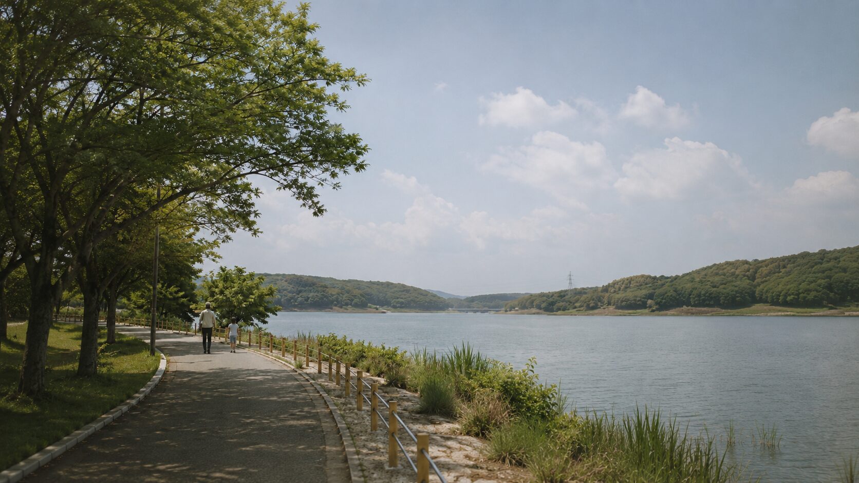 愛知池の水辺に沿って歩く道。木陰と湖面が続く、東郷らしい大きな景色。